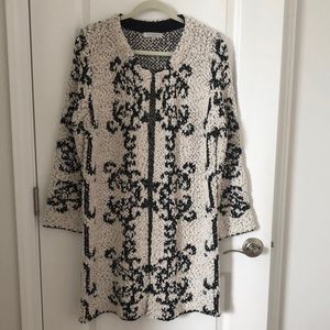 Sweater coat with long sleeves.